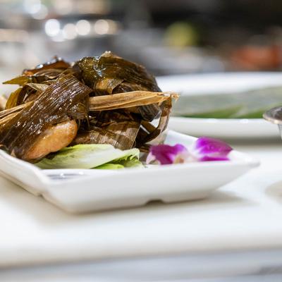 Sish of marinated chicken wrapped in pandan leaves.