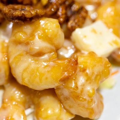 Close-up of creamy glazed shrimp with walnuts.