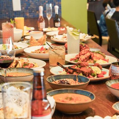Restaurant table covered with assorted dishes and beverages.