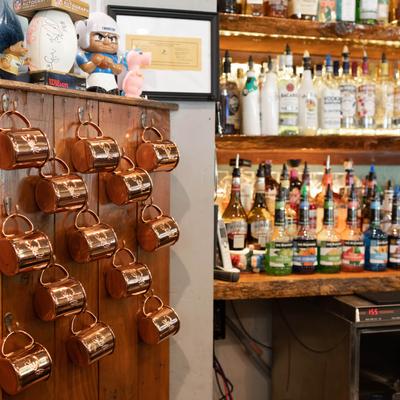 Liquor bottles and copper mugs.