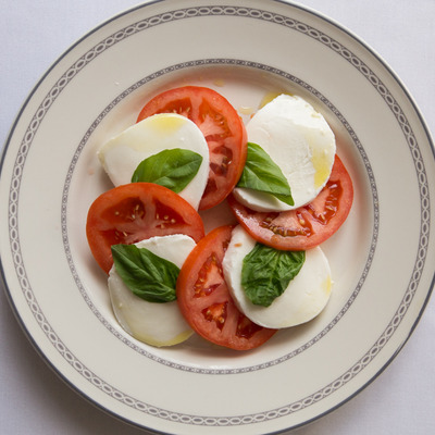 Caprese salad, with mozzarella, tomatoes, basil, and olive oil.