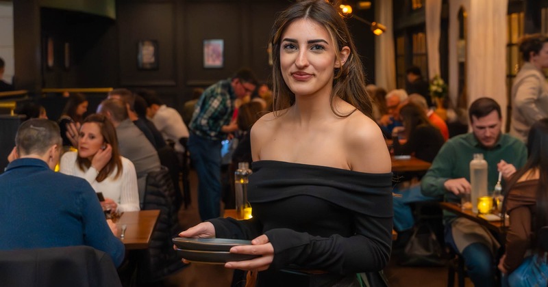 Employee carrying plates