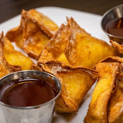Crispy Crab Wontons served with dipping sauces, close-up.