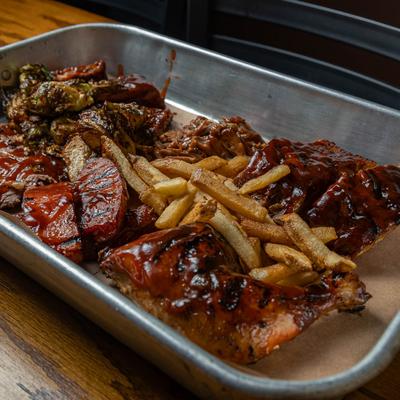 Sampler platter with all house smoked meats and a side of fries.