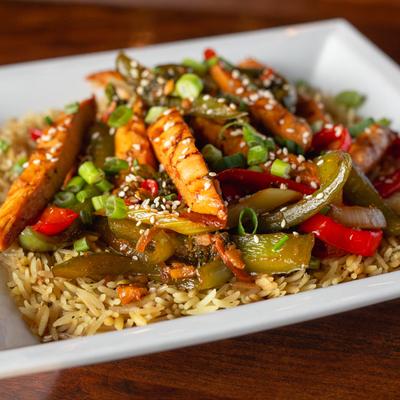 Vegetables sauteed in ginger-soy sauce over rice pilaf.