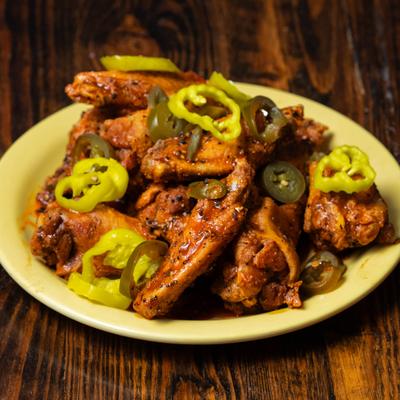 Shearon Harris wings topped with sliced peppers.