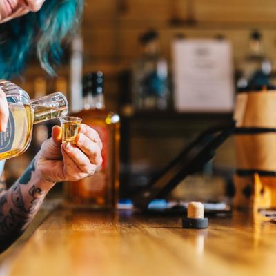 HAnds serving a drink.