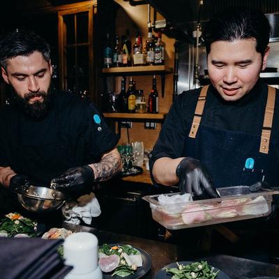Chefs garnishing salads.
