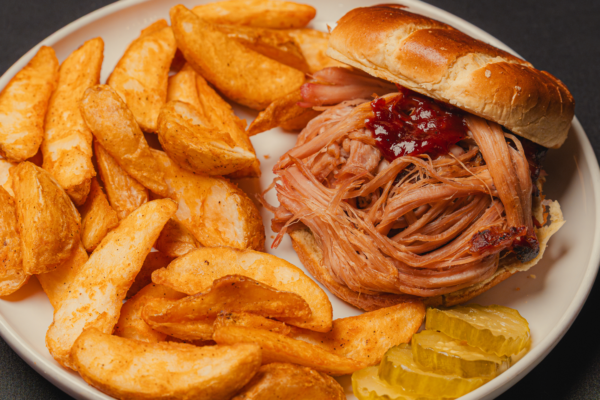 Cherry- and hickory-smoked pulled pork sandwich