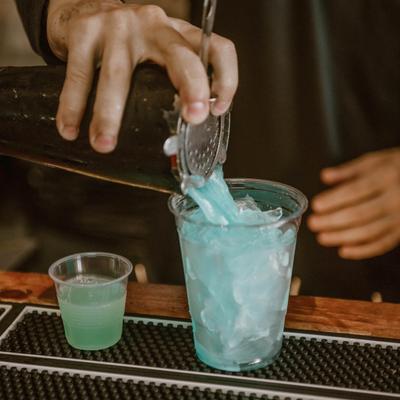 Bartender pouring a cocktail.