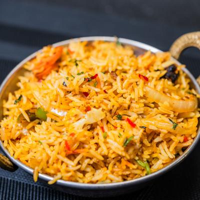 Veg Biryani served in a metal dish.