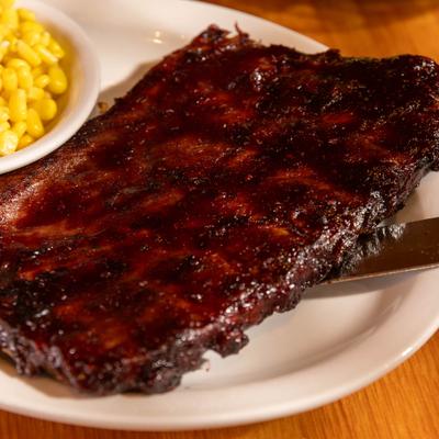 Rack of BBQ Ribs served with sweet corn.