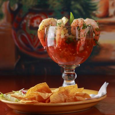 Shrimp cocktail with a plate of tortilla chips