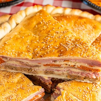 Stuffed pie, with ham, sausage, meatballs, salami, pepperoni, and mozzarella.