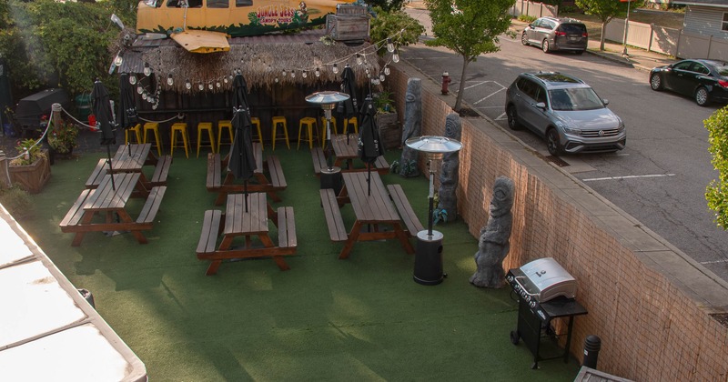 Outdoor patio with picnic tables, a yellow airplane model