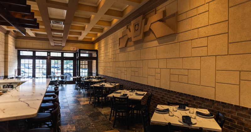 Interior, dining area with a bar, tables and chairs