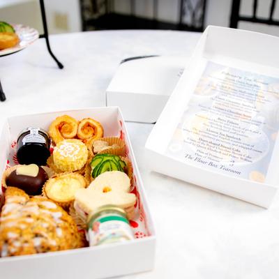 Cookies in a tea service box for a reception.