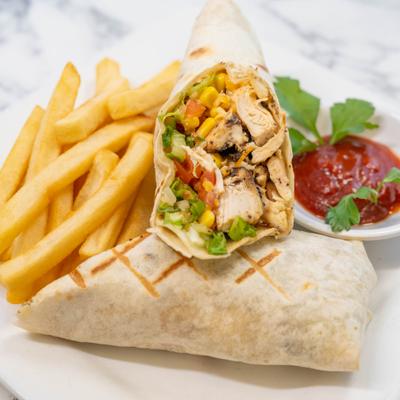 Jerk chicken wrap served with fries and a dipping sauce.
