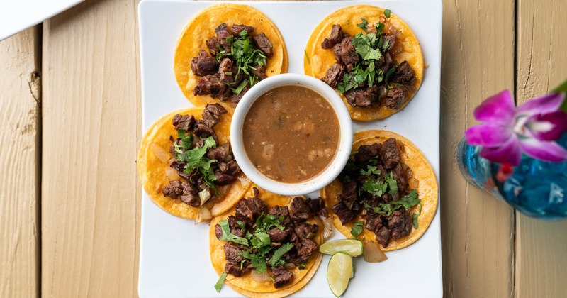 Steak tacos with cilantro served with beans