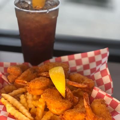 Breaded and fried prawns and fries, served with a drink