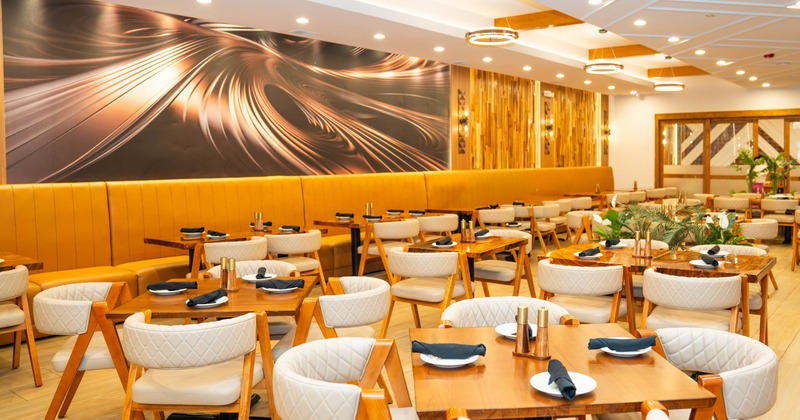 Interior, open space dining area, regular tables for four and two, banquette seating