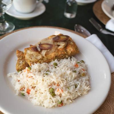 Grilled chicken, with lemon butter, grilled onions, and rice.