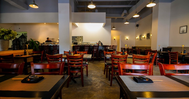 Interior, wooden tables and chairs, bar area in the back