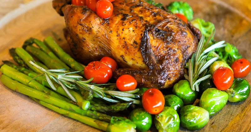 Roasted chicken with Brussels sprouts, cherry tomatoes, asparagus, rosemary