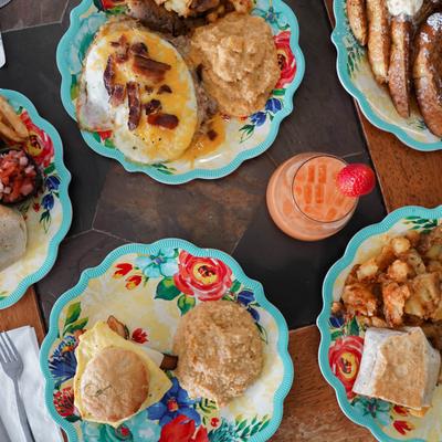 Breakfast dishes and a cocktail on a table.