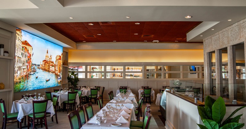 Interior, seating area with green chairs and tables