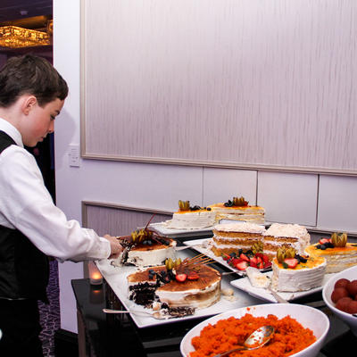 A young man picking a dessert