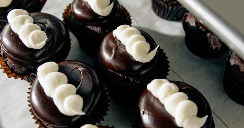 Chocolate cupcakes topped with cream