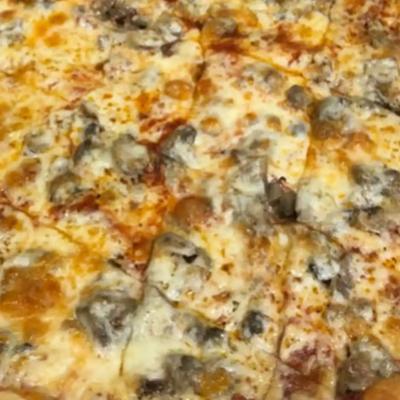 Mushroom pizza topped with melted cheese.