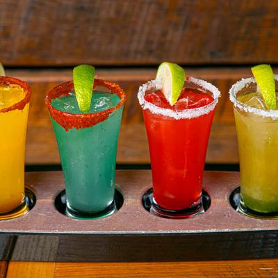 A cocktail flight of colorful drinks.