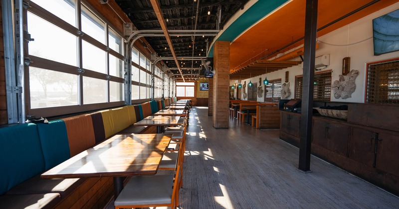 Interior, spacious dining area with banquette, tables and chairs