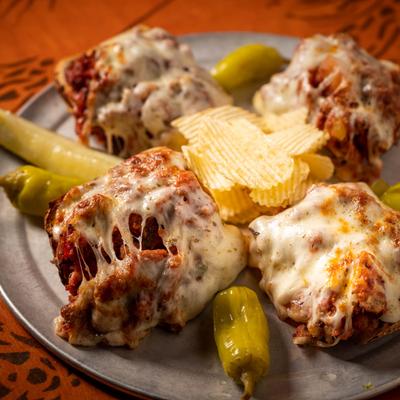 Stromboli covered in melted cheese, with jalapenos and potato chips