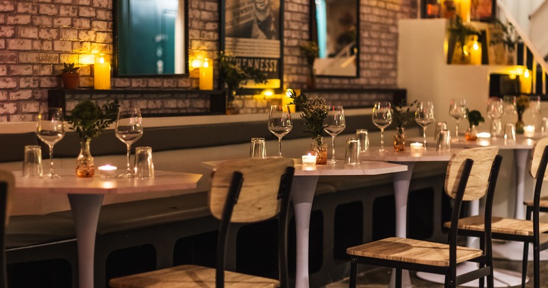 Modern style interior design with lined up wooden chairs and white tables