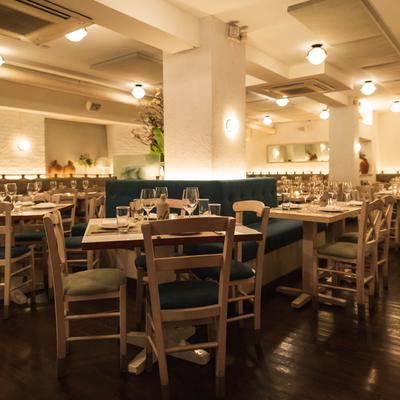 Large dining area, with tables, chairs and banquette seats.
