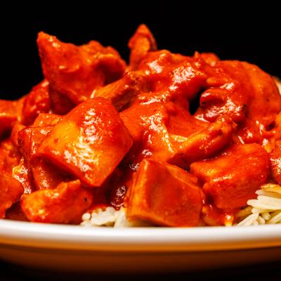Tomato-based butter chicken, close-up.