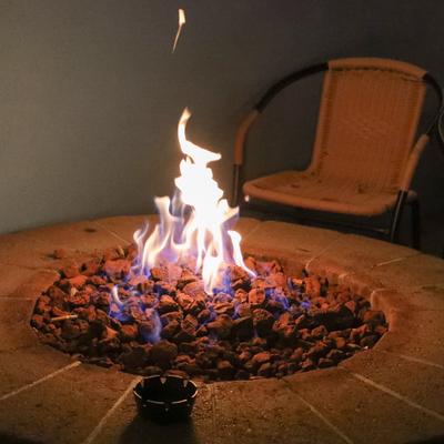 Patio area, a lit firepit table and chairs.