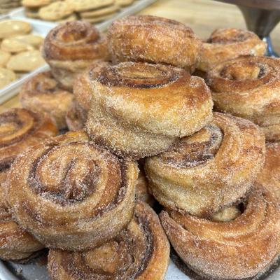 A plate of sugar-coated cinnamon rolls.