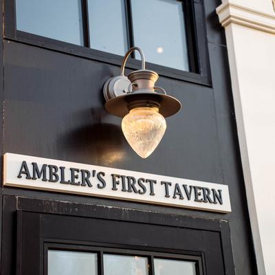 Ambler's First Tavern and an outdoor wall light.
