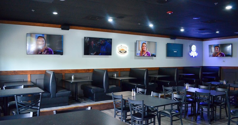 Dining booths and tables, TV screens on the wall