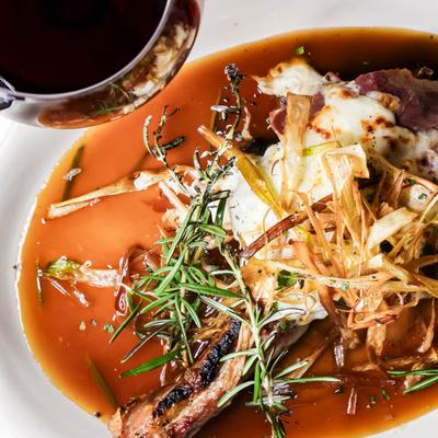 Grilled Veal Chop topped with prosciutto and mozzarella in a cognac vermouth sauce.