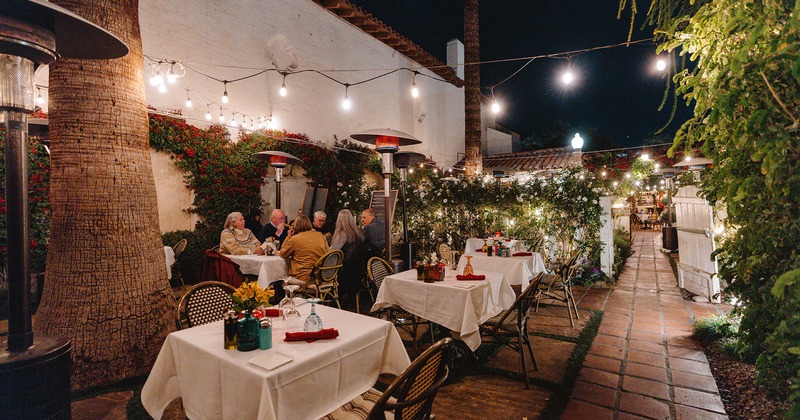 Patio area at night, guests enjoying their meals