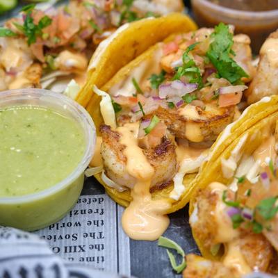 Grilled Shrimp Tacos, with chipotle aioli, cabbage, and pico de gallo.