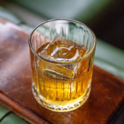 Whiskey with ice in glass.