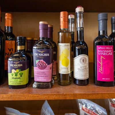 Interior, Assorted Italian vinegar bottles on a shelf.