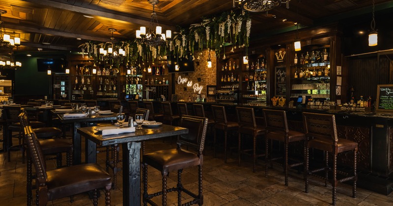 Interior, bar and high seating area, bar with stools, high tables for two, exposed brick walls