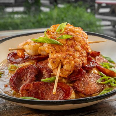 Shrimp and grits with sausage and scallions.